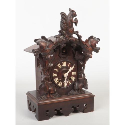 65 - A 19th century Black Forest cuckoo clock striking on a gong. Carved with a squirrel and acanthus lea... 