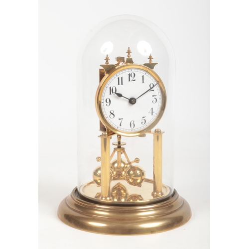 69 - An early 20th century brass torsion clock under glass dome. With white enamel dial having Arabic num... 