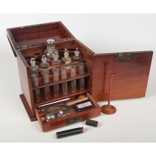 62 - An early 19th century mahogany travelling medicine chest or apothecary cabinet. Opening to reveal a ... 