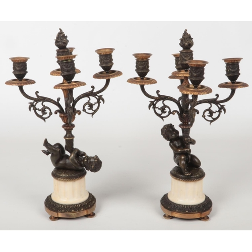 68 - A pair of 19th century French parcel gilt bronze and marble five branch candelabra raised on flatted... 