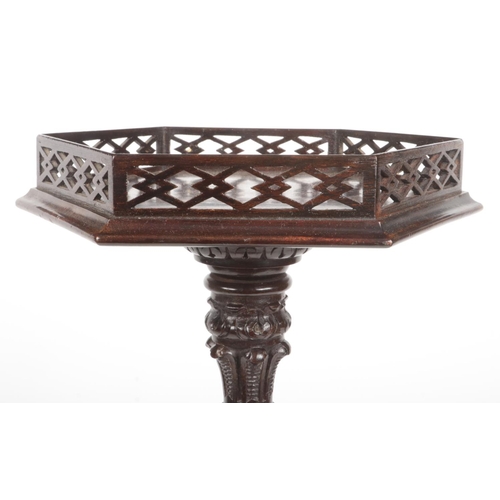 281 - A Chippendale style mahogany wine table with hexagonal top having open fret gallery. Raised on an op... 