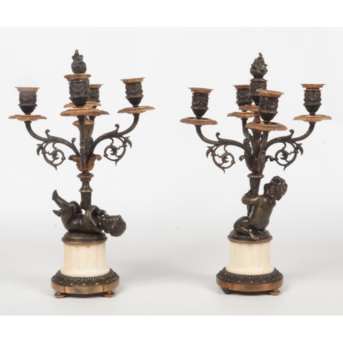 68 - A pair of 19th century French parcel gilt bronze and marble five branch candelabra raised on flatted... 