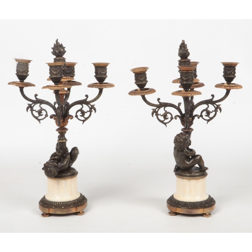 68 - A pair of 19th century French parcel gilt bronze and marble five branch candelabra raised on flatted... 