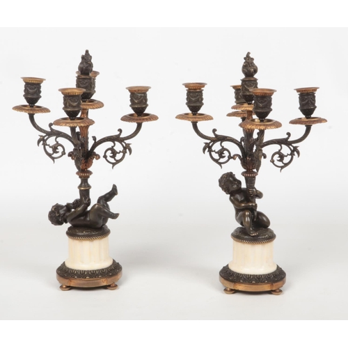 68 - A pair of 19th century French parcel gilt bronze and marble five branch candelabra raised on flatted... 