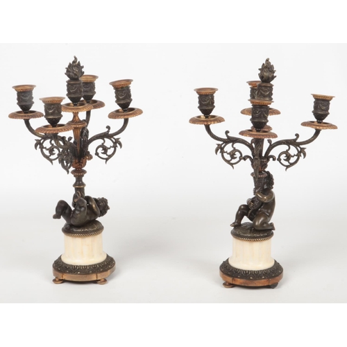 68 - A pair of 19th century French parcel gilt bronze and marble five branch candelabra raised on flatted... 