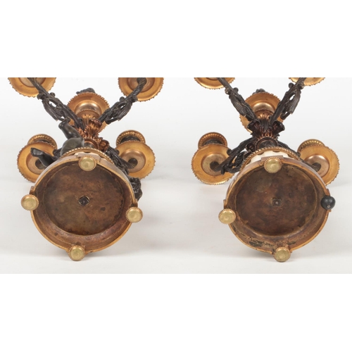 68 - A pair of 19th century French parcel gilt bronze and marble five branch candelabra raised on flatted... 