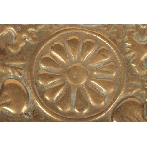 78 - A 17th century brass alms dish. Embossed with a rosette centre under a gadrooned well and with a pun... 