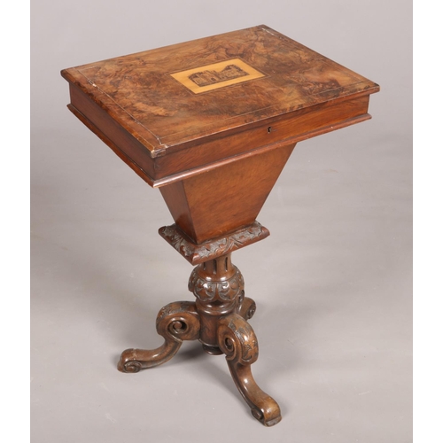 446 - A Victorian figured walnut work table with Killarney inlaid panel to the top and raised on carved sc... 