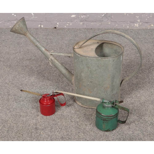 356 - A Aluminium watering can with two oil cans