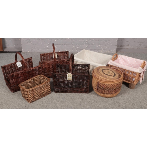 370 - A collection of wicker baskets, three wicker log baskets, four storage baskets