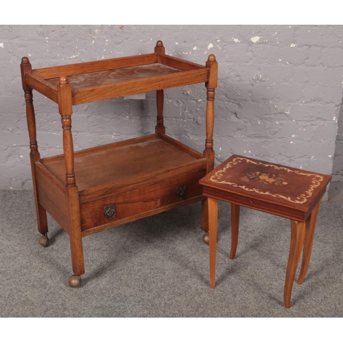 416 - An oak two tier tea trolley with drawer, along with an Italian style musical sewing table.