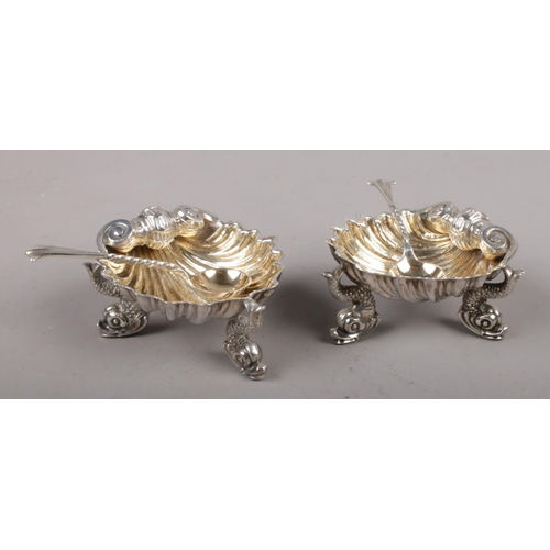 305 - A pair of Victorian silver shell formed salt cellars, with dolphin supports, assayed London 1872 (70... 