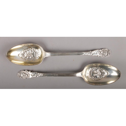 312 - A pair of Victorian silver berry spoons, with gilt bowls embossed with green man masks, assayed Lond... 