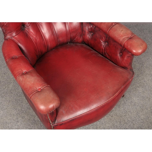 447 - A deep and shallow buttoned red ox blood leather armchair.