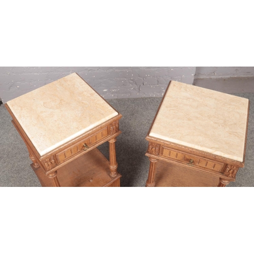 450 - A pair of French light oak carved and panelled marble top pot cupboards, with reeded columns and rai... 