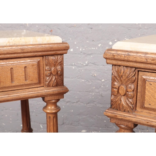 450 - A pair of French light oak carved and panelled marble top pot cupboards, with reeded columns and rai... 