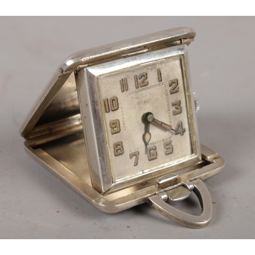 292 - A continental silver cased art deco folding beside timepiece, Signed Novelti with black and blue ena... 