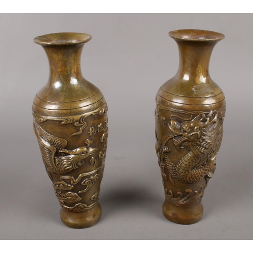 332 - A pair of Chinese bronze vases decorated with Fenghuang and Kylin. Character marks to base.