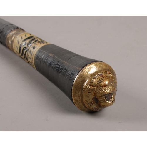 337 - An ebonised sword stick with brass lion mask pommel, 92cm length.