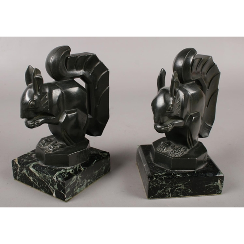 338 - Max Le Verrier (French 1891-1973) a pair of art deco verdigris bronze figures. Each formed at a squi... 