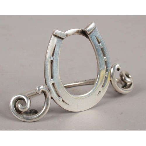 339 - A Victorian silver equestrian menu holder formed as a horse shoe, assayed London 1896 by Cornelius J... 