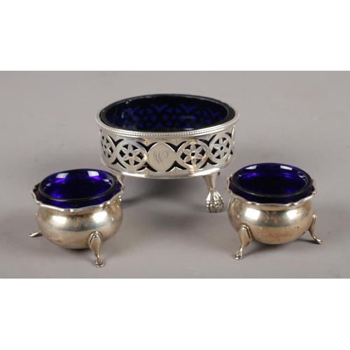 342 - A Georgian silver salt cellar with Bristol blue glass liner, along with a pair of George V salt cell... 