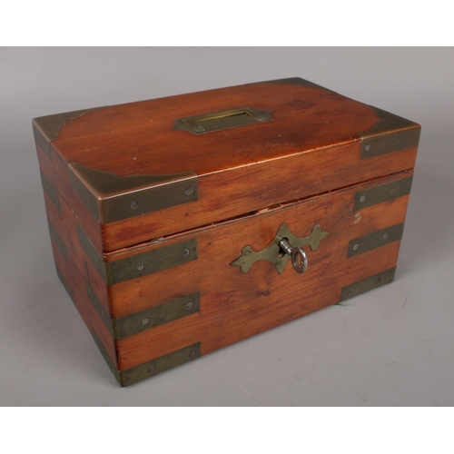 69 - A 19th century yew wood campaign box with brass mounts, working locks and key.