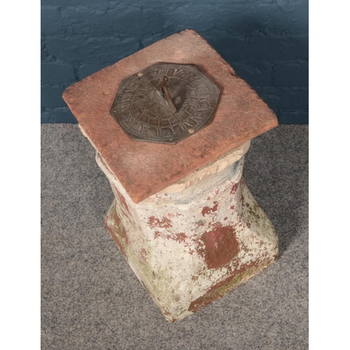 364 - A composition stone base pedestal sundial (49cm height 30cm width)