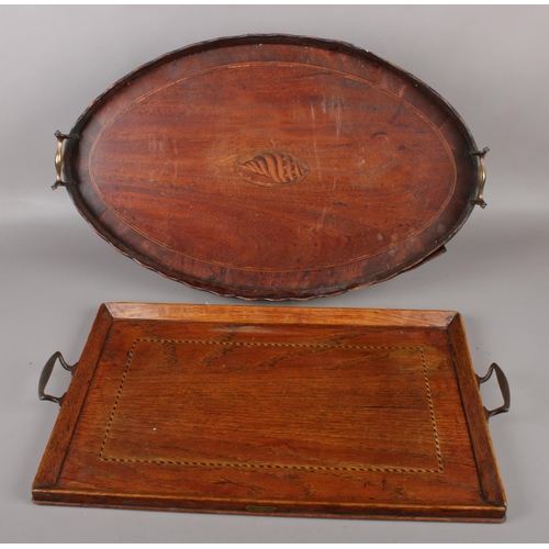 74 - A Victorian mahogany twin handled serving tray with inlaid shell patera motif, along with a similar ... 