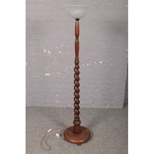 377 - An oak turned floor lamp stand with circular base and glass up shade. Height 140cm.