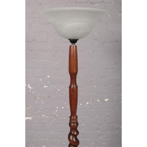 377 - An oak turned floor lamp stand with circular base and glass up shade. Height 140cm.