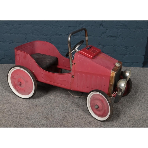 382 - A vintage metal and chrome child's pedal car with number plate 1938. Length 77cm, width 40cm.