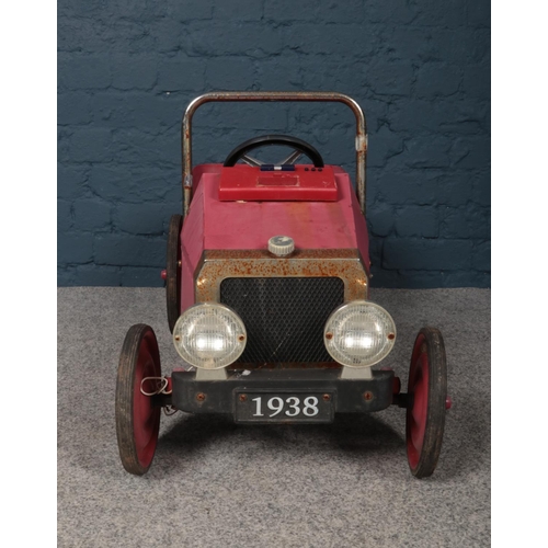 382 - A vintage metal and chrome child's pedal car with number plate 1938. Length 77cm, width 40cm.