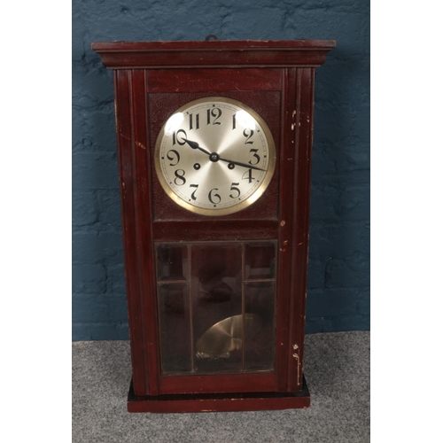 386 - Two wooden wall mounted pendulum clocks, comprising of a Pendulum clock which is decorated with a sh... 