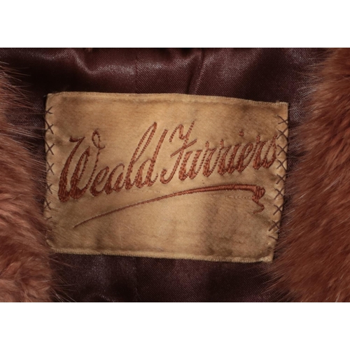 395 - A Ladies three quarter length fur coat, label for Weald Furriers.