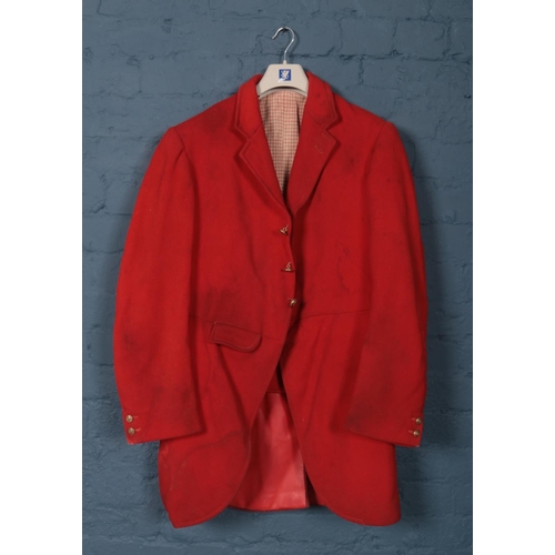 396 - A red Huntsman jacket with brass monogrammed buttons. (Pit to pit approximately 45cm).