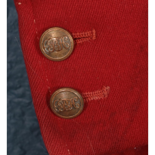 396 - A red Huntsman jacket with brass monogrammed buttons. (Pit to pit approximately 45cm).