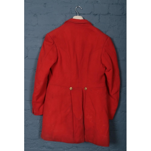 396 - A red Huntsman jacket with brass monogrammed buttons. (Pit to pit approximately 45cm).