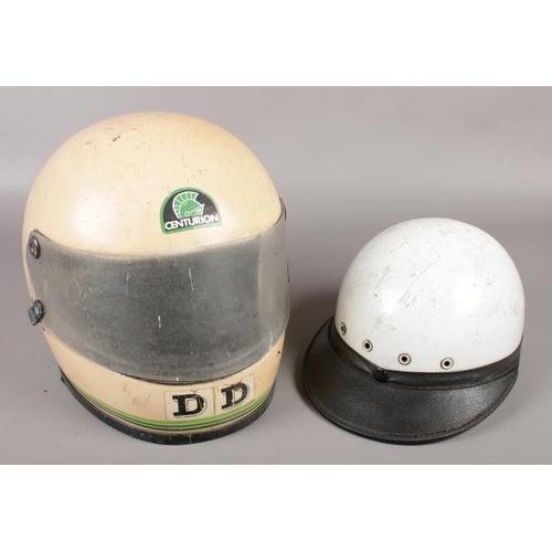 398 - Two vintage motorcycle helmets, to include Slazenger Defender and another bearing Centurion sticker.