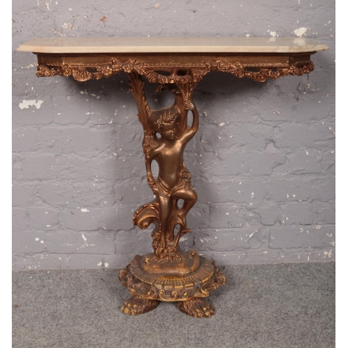 417 - A Rococo-style gilt wood and simulated marble topped console table, decorated with a central cherub ... 