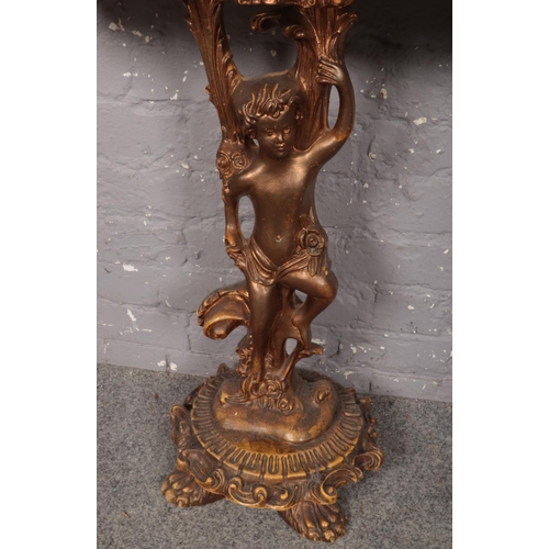 417 - A Rococo-style gilt wood and simulated marble topped console table, decorated with a central cherub ... 