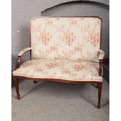 419 - A Salon Suite comprising of a two seated settee and elbow chair, upholstered in a cream and floral p... 