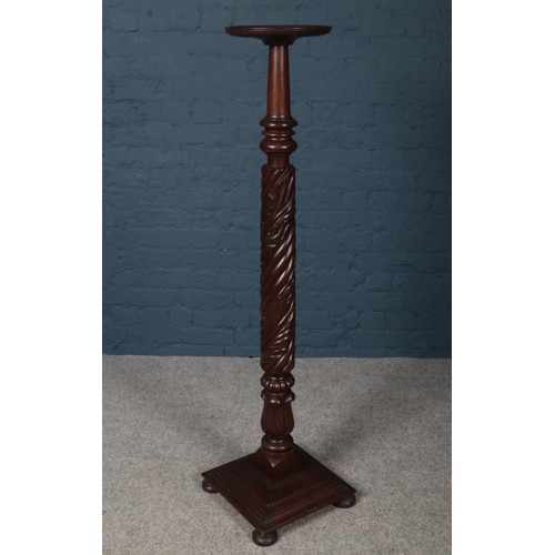 420 - A carved Mahogany Torchere (Plant Stand) with square base. Height 137cm.