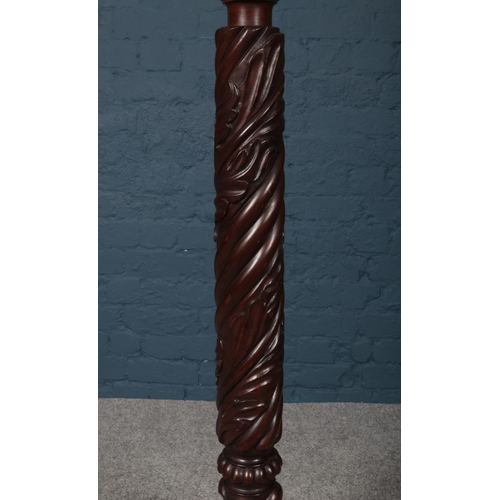 420 - A carved Mahogany Torchere (Plant Stand) with square base. Height 137cm.