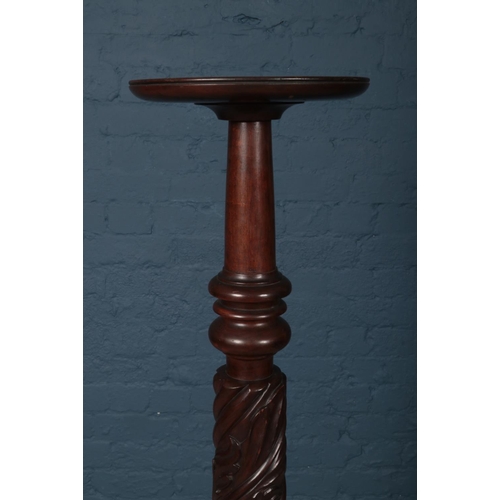 420 - A carved Mahogany Torchere (Plant Stand) with square base. Height 137cm.