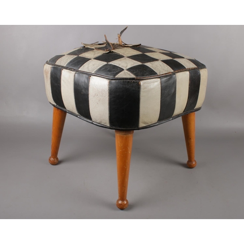 422 - A Mid century Sherborne 'Tele-Pouffe', with beechwood legs and checker-board leather design. Height ... 