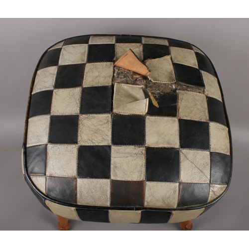 422 - A Mid century Sherborne 'Tele-Pouffe', with beechwood legs and checker-board leather design. Height ... 