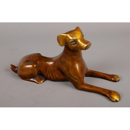 86 - A bronze recumbent dog.