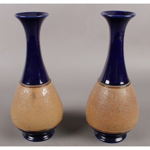 117 - A pair of Royal Doulton stoneware vases. (28cm tall)