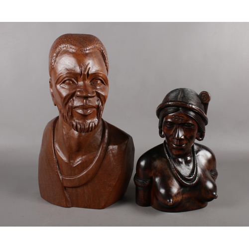 124 - An African caved wooden head and shoulder bust of a man from one single piece of wood. Height 43cm, ... 